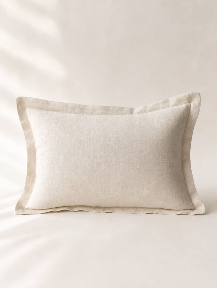A small ivory boudoir pillow, about 18 by 12 inches, ready for a monogram.